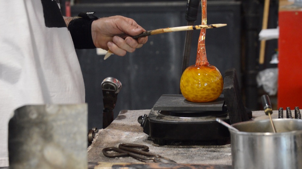 A Third Degree Glass Factory worker gives the final details to his new creation: a pumpkin. The factory was founded in 2002 by Wash U. alum Jim McKelvey and his friend Doug Auer.