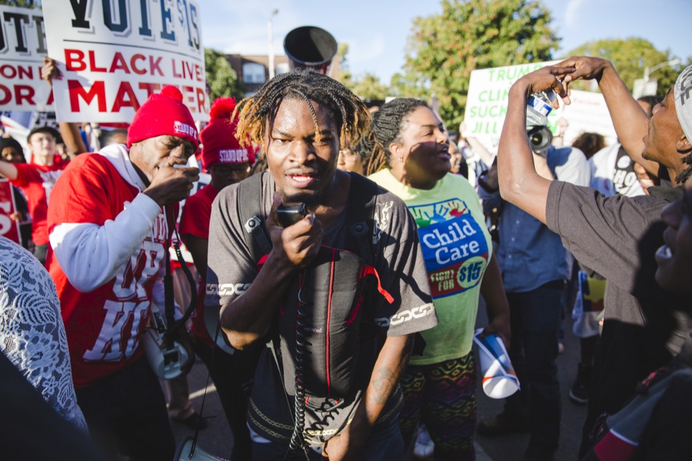 A protestor yells into a megaphone at the Say No to Hate protest on the Delmar Loop Sunday Oct. 9. The protest brought together members of the Wash. U. and St. Louis community to speak out against various injustices.