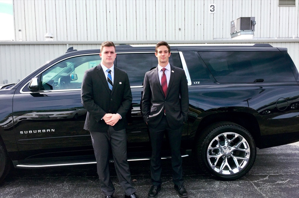 Sophomores Eric Kibbey, left, and Dylan Brambora stand in front of a Suburban used in Donald J. Trump’s motorcade on Sunday, Oct. 9, 2016. The two were asked to volunteer after a Trump campaign staffer saw a conservative sign hanging in their fraternity house.