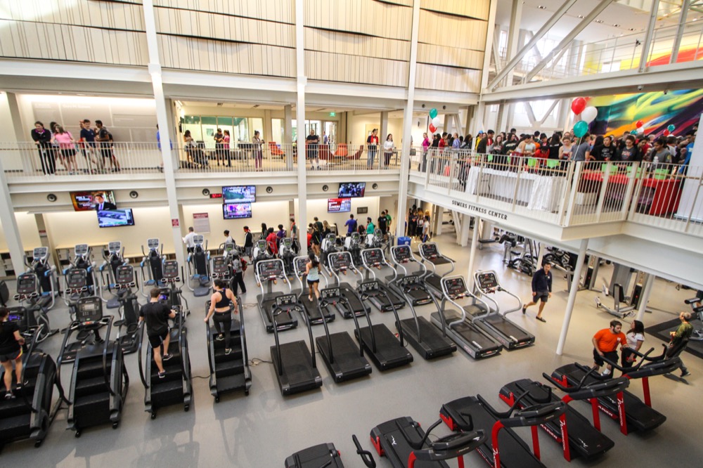Community members file in and submit raffle entries on the third floor of the Sumer Recreation Center as students work out on the cardio and weight floor.
