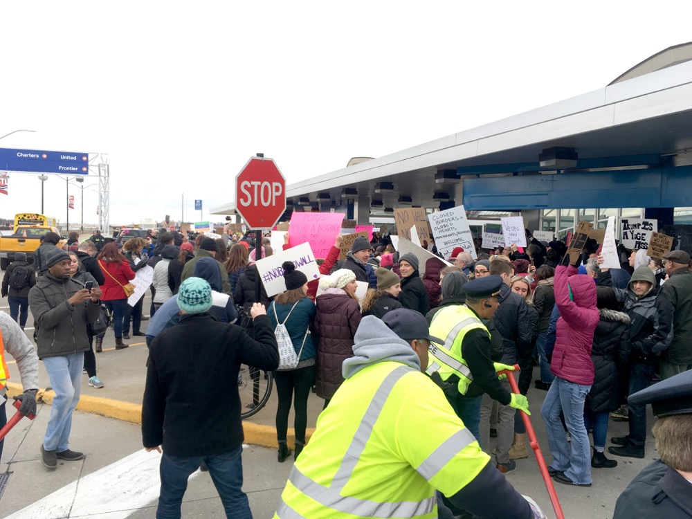 Protestors congregate outside Terminal 1 at Lambert-St. Louis International Airport.