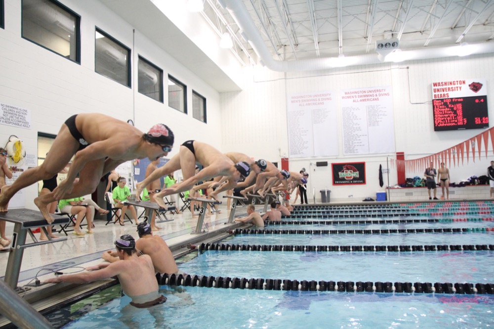 Swimmers jump off the starting blocks during a Wash. U. swim meet aganist Truman State. The men’s swimming and diving team took second at the UAA championships meet this weekend.