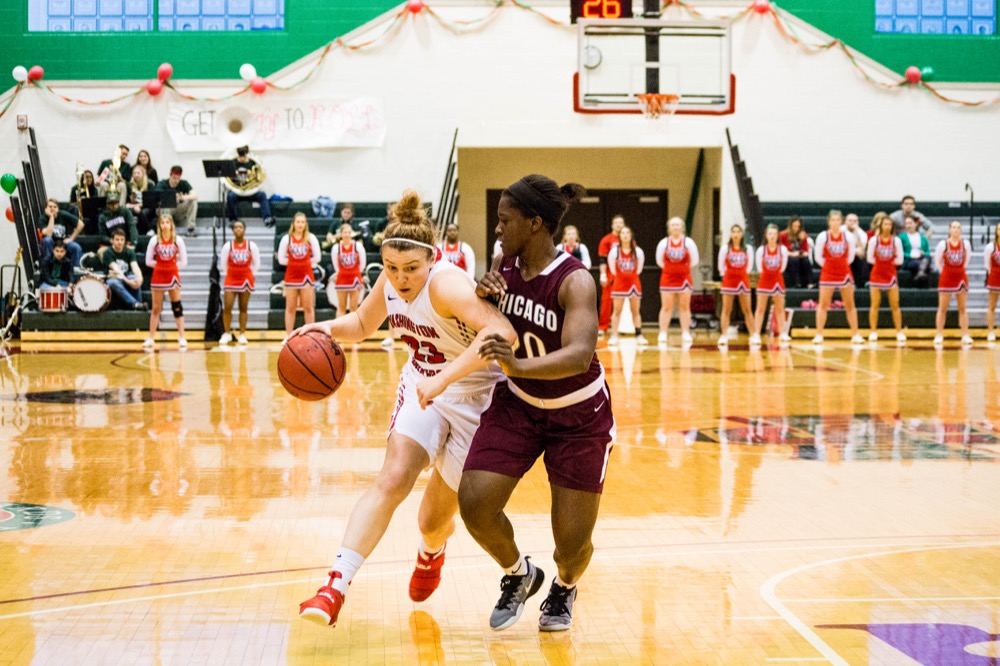 Senior Jenn Dynis drives around her defender to get to the basket in the Bears’ game aganist the University of Chicago. The Bears play in the first round of the NCAA tournament this weekend.