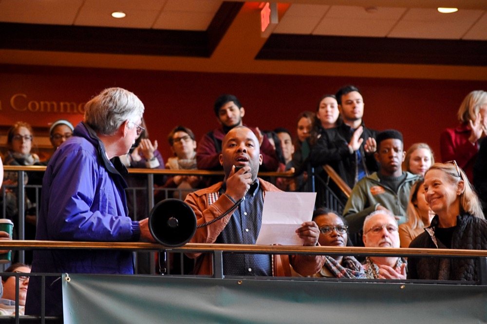 Professor Jeffrey McCune reads a letter drafted by students and faculty addressing their support for making Washington University a sanctuary campus. A “speak- out” in support of this initiative was held yesterday afternoon in the Danforth University Center and was attended by undergraduates, graduates and professors.