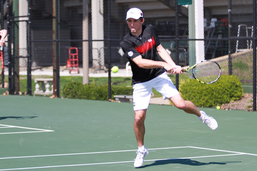 Sophomore Konrad Kozlowski hits a backhand in the match against the Rhodes College last year. The sophomore picked up a win with partner junior Jason Haugen against Wabash College Friday. 