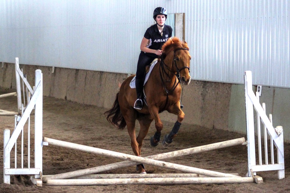 Freshman Emme Wiederhold of the Washington University equestrian team warms up with her horse during one of the team’s practices. There are 45 members, including graduate students, currently involved with the team, which practices at Baskin Farms in Glencoe, Mo.