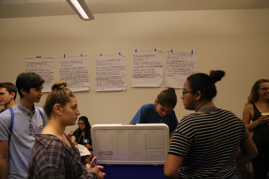 Students gather around at Environmental JustICE Cream Social, held in Seigle Hall Wednesday. The event featured free ice cream from Clementine’s, a popular local ice cream parlor.