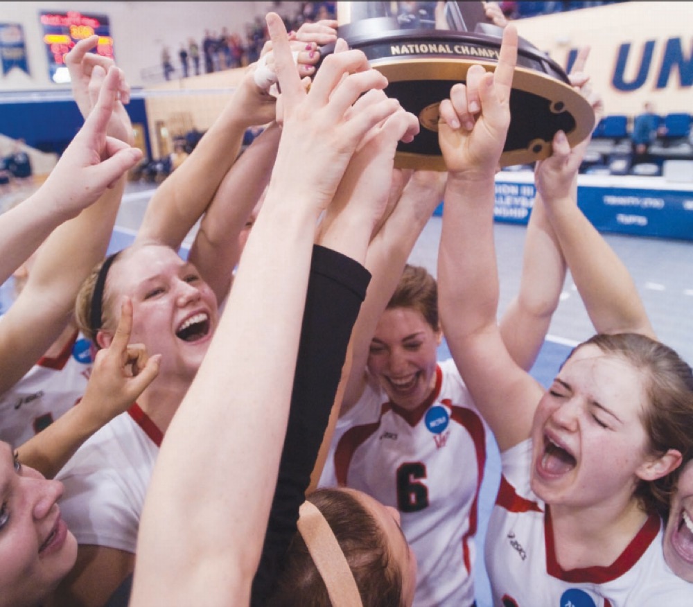 The 2009 women’s volleyball team hoists its trophy into the air after winning the 10th Division III national championship in the program’s history.