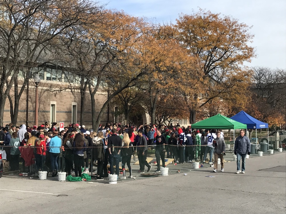 Students stand in line in the Simon parking lot before the Bears’ football game Saturday. The event included free food, as well as free alcohol for those aged over 21.