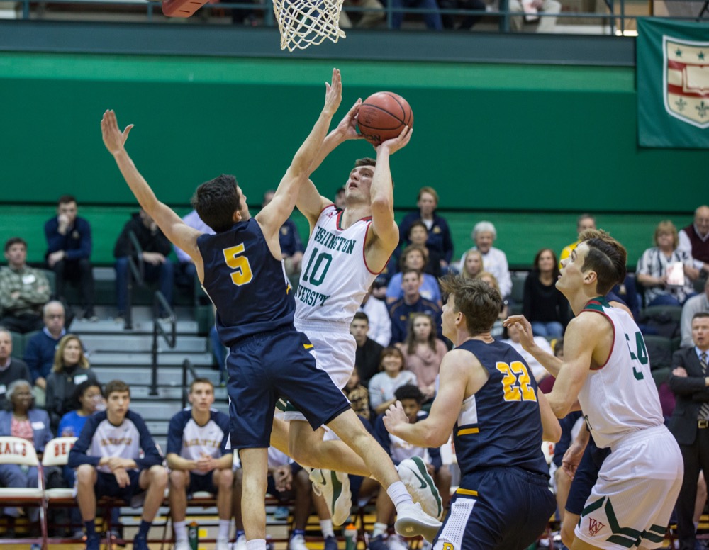 Senior Kevin Kucera fights through the University of Rochester defense during the Bears’ Friday night game. The Bears secured a 77-63 win against Rochester to go on a nine-game consecutive win streak, and they brought the streak to 10 with a win against Emory Sunday.