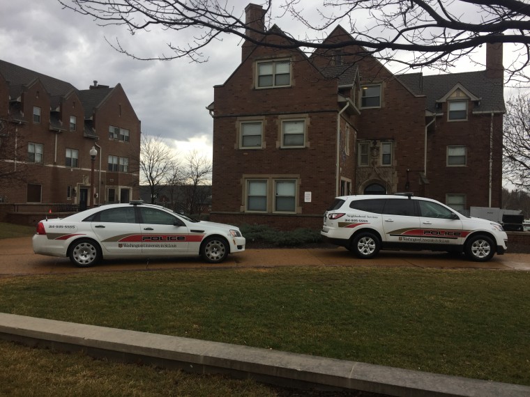 Police cars sit outside the Phi Delta Theta house Feb. 20.