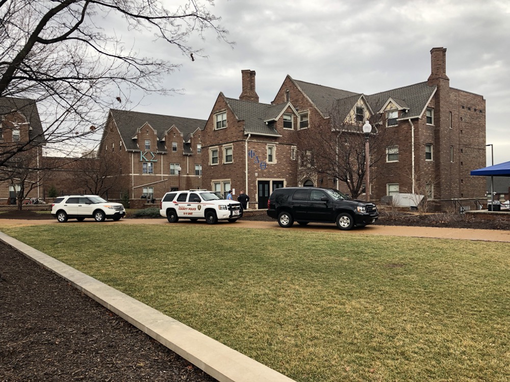 St. Louis County Police and Washington University Police Department cars sit outside the Phi Delta Theta house Tuesday afternoon. WUPD searched and found guns in the house after receiving an anonymous tip that a member of the fraternity possessed firearms which were kept in the on-campus house.