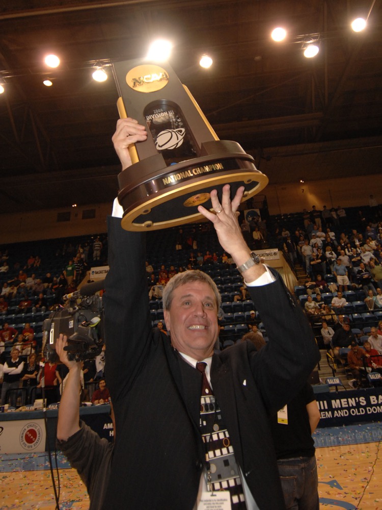 Mark Edwards lifts the 2008 national championship trophy, one of the two he’s won as head coach of the men’s basketball team.