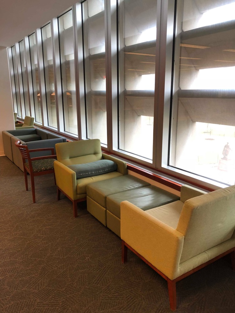 Two chairs and two ottomans in Olin Library serve as a bed.