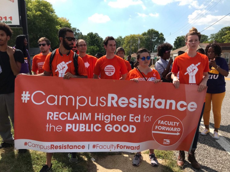 Members of the Washington University Graduate Worker's Union march as part of a McDonald's employee #MeToo rally about workplace harassment and discrimination in St. Louis