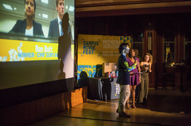 A student is awarded a prize as one of the creators of “Man Butt,” one of the top four films at the Campus Movie Fest.