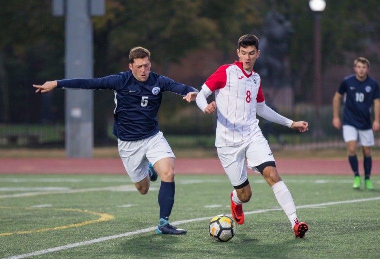 Senior Kyle Perez competes for the ball with a Brandeis University midfielder Friday. The Bears defeated Brandeis, 2-0, before drawing 1-1 against New York University Sunday.