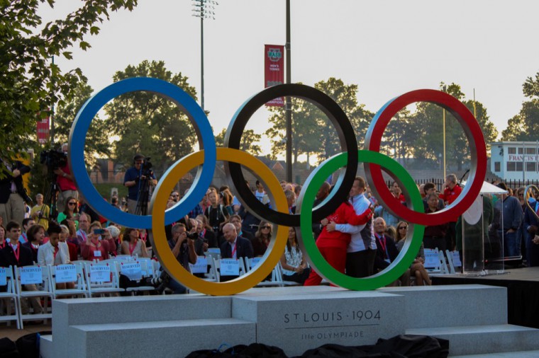 Spectators celebrate the unveiling of the Olympic rings sculpture next to the site of the 1904 games. The event was attended by Wash. U. students, faculty and the surrounding community.