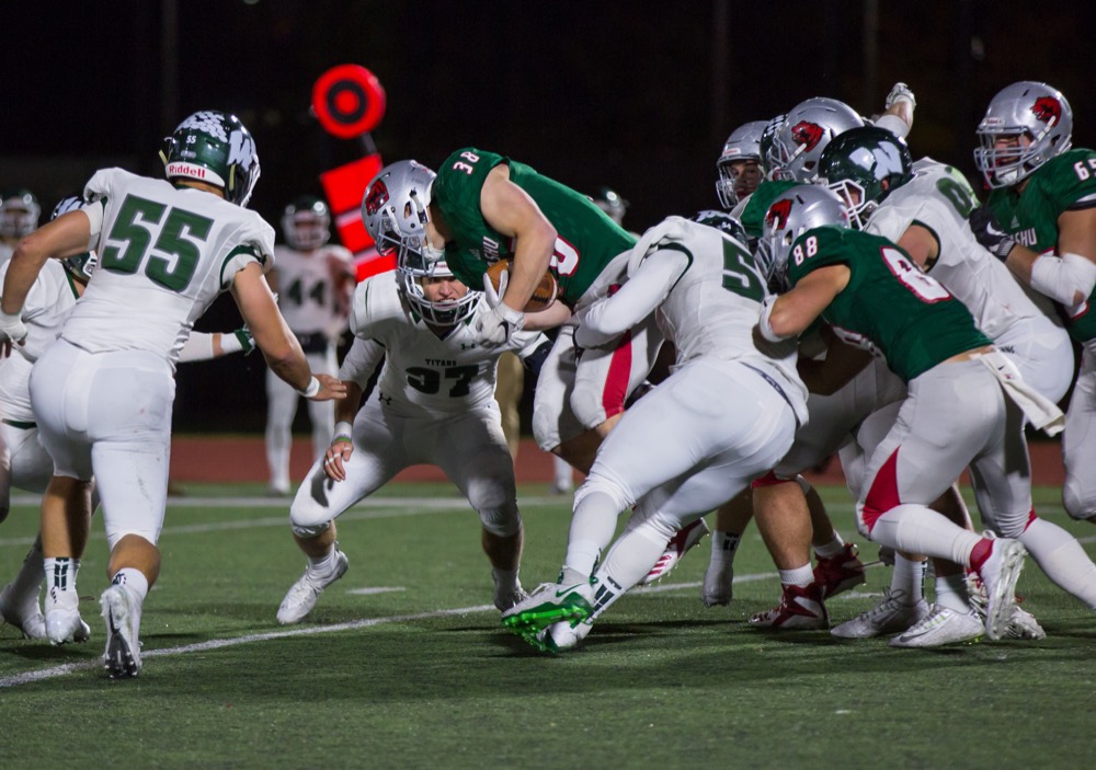 Junior John Fisher carries the ball past Illinois Wesleyan University defense. Fisher ran a career-high 179 yards to lead the Bears football team to a 49-42 victory over Millikin University.