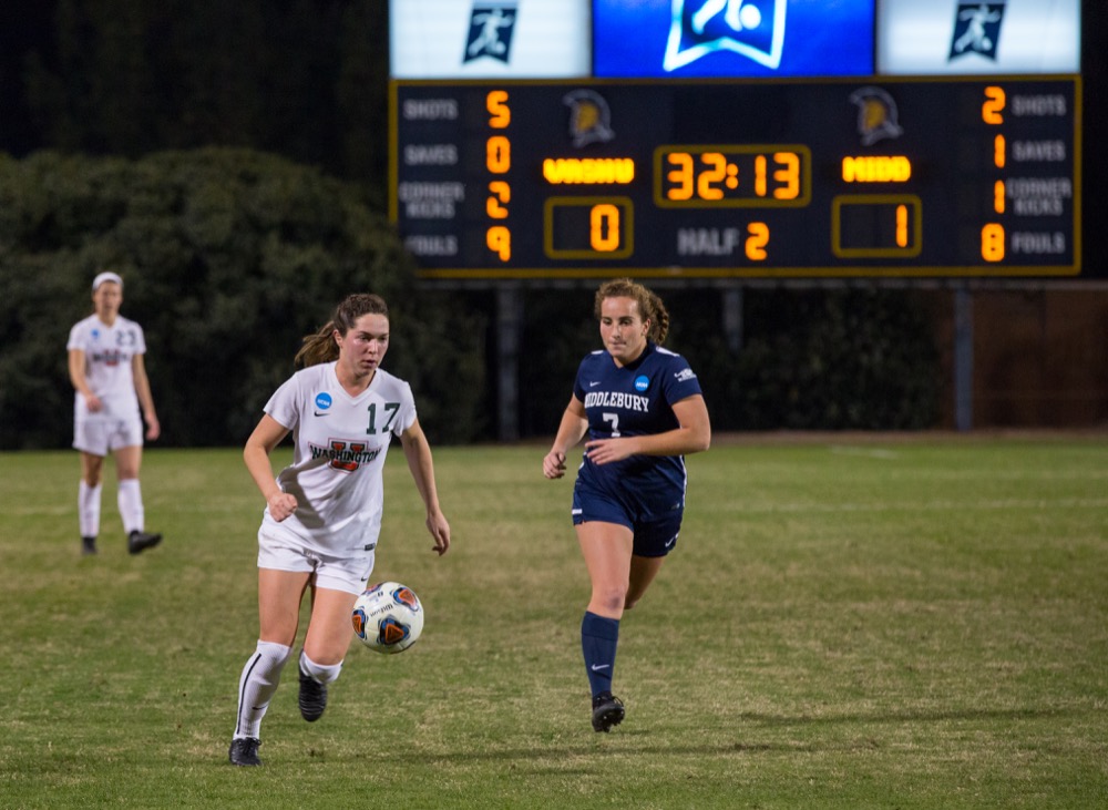 Darcy Cunningham carries the ball against a Middlebury defender in the NCAA semifinal Nov. 30. After a 21-0 season, the Bears lost 1-0 to the No. 3 Panthers and were eliminated.