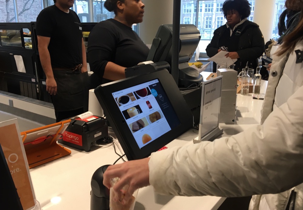 Students use the new ordering kiosk in Whispers Cafe. Dining Services introduced the system this semester to allow students to skip traditional, in-person registers. The University hopes to expand the program in future.