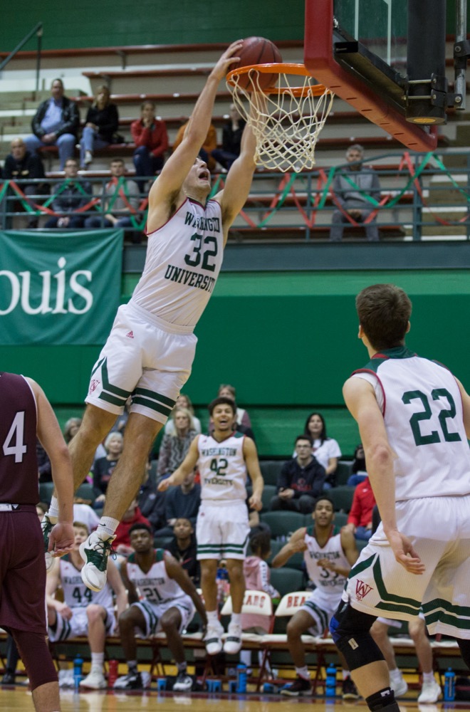 Justin Hardy throws down an alley-oop from sophomore guard Jack Nolan against the University of Chicago, Feb. 23.