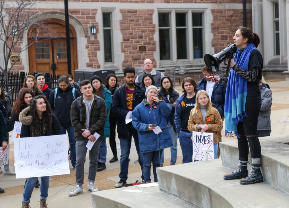 Students, faculty and members of the Washington University community gather at a Fossil Free WashU rally Friday afternoon in Edison Courtyard. The protesters gathered to urge the University to divest from fossil fuels.