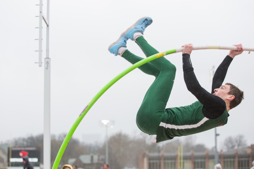 Tim Goblirsch lifts himself through the rain Saturday afternoon at the WashU Invitational. Goblirsch was one of fourteen Wash. U. first place finishes and won pole vault at 4.10 meters.