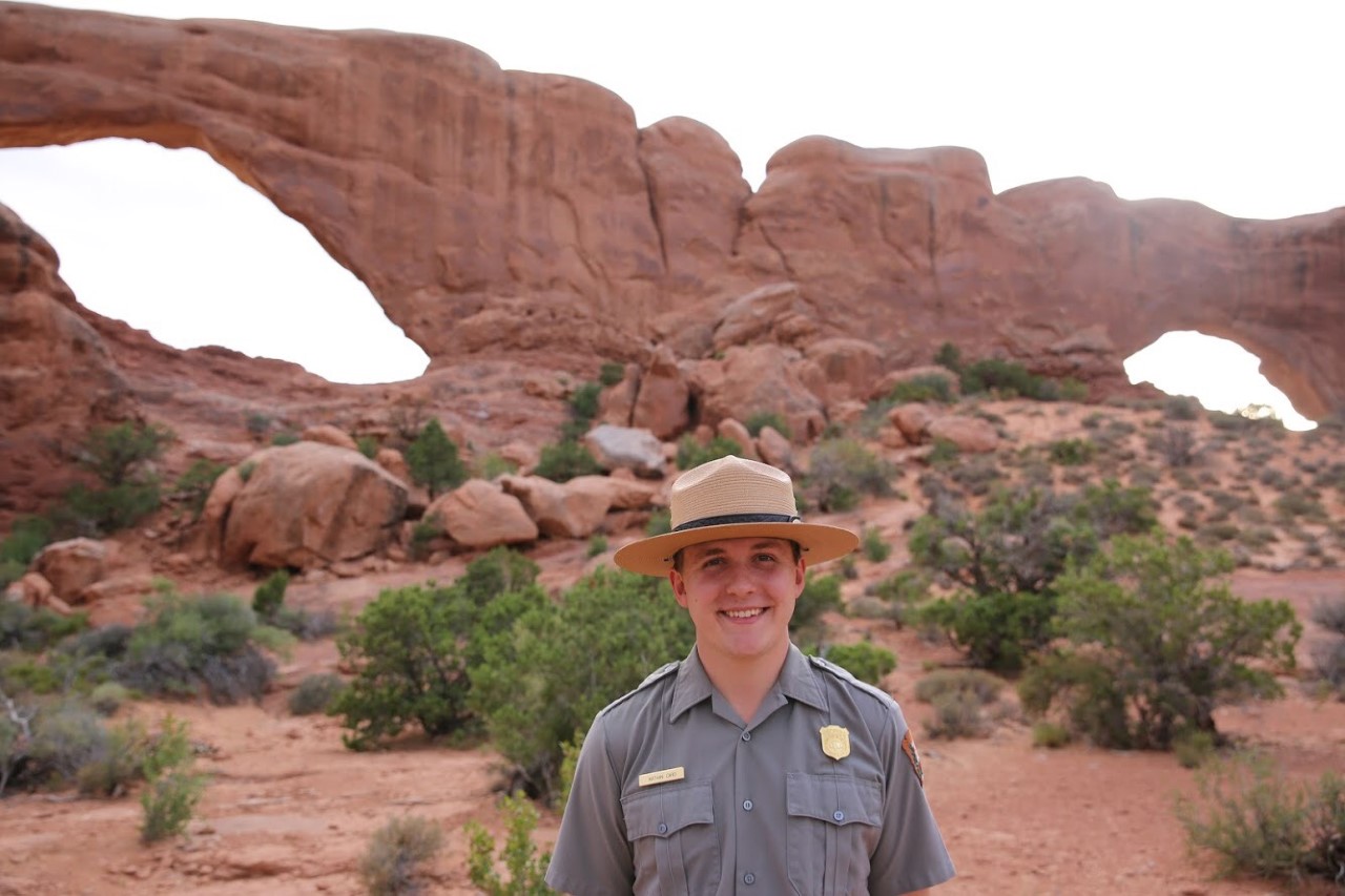 Recent Wash. U. graduate Nathan Card stands at Arches National Park.