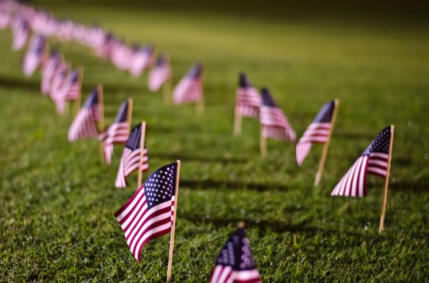 9/11 memorial flags wave on Mudd Field.