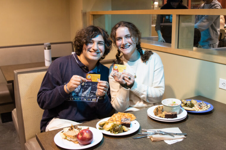 Zach and Lily gleefully show off their “All You Care to Eat” dining survey cards.
